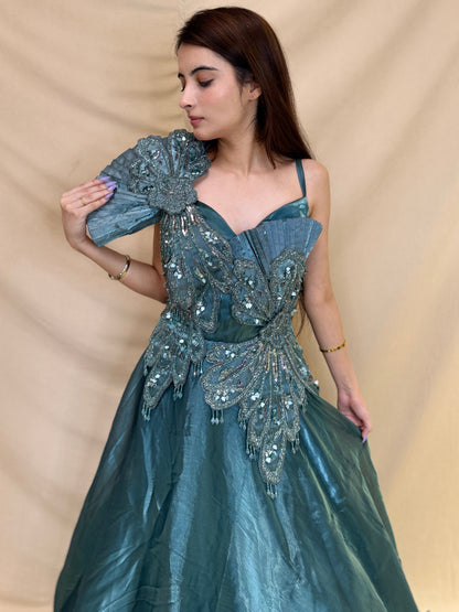 Turquoise Blue party wear gown in cosmos fabric and detailed with stones, cutdana and sequin.